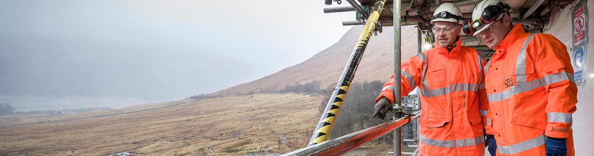 Two ORR inspectors in high visibility clothing and personal protective equipment on a health and safety visit in December 2019 to the Auch Viaduct (UB 310/151) and a nine span, steel railway viaduct near Tyndrum on the West Highland line