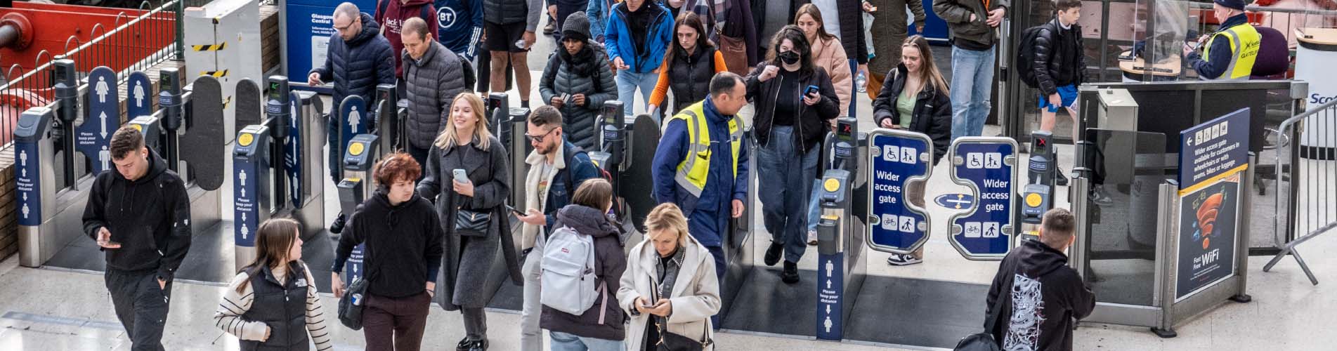 Passengers through ticket gates at Glasgow Central train station
