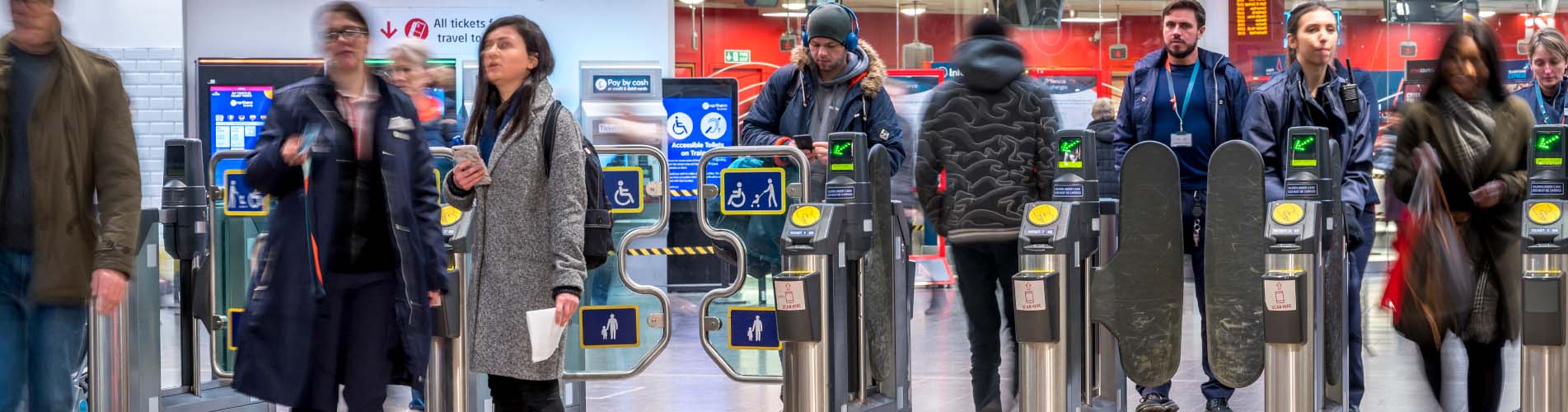 Passengers through ticket gates at Manchester Piccadilly station