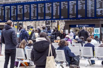 Passengers view Glasgow Central station departure boards