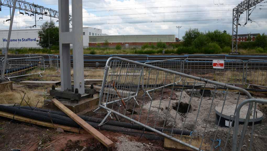 Excavation work outside Stafford railway station around bars that show where a worker was injured from being buried