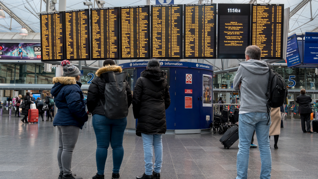 Passengers looking at departure board