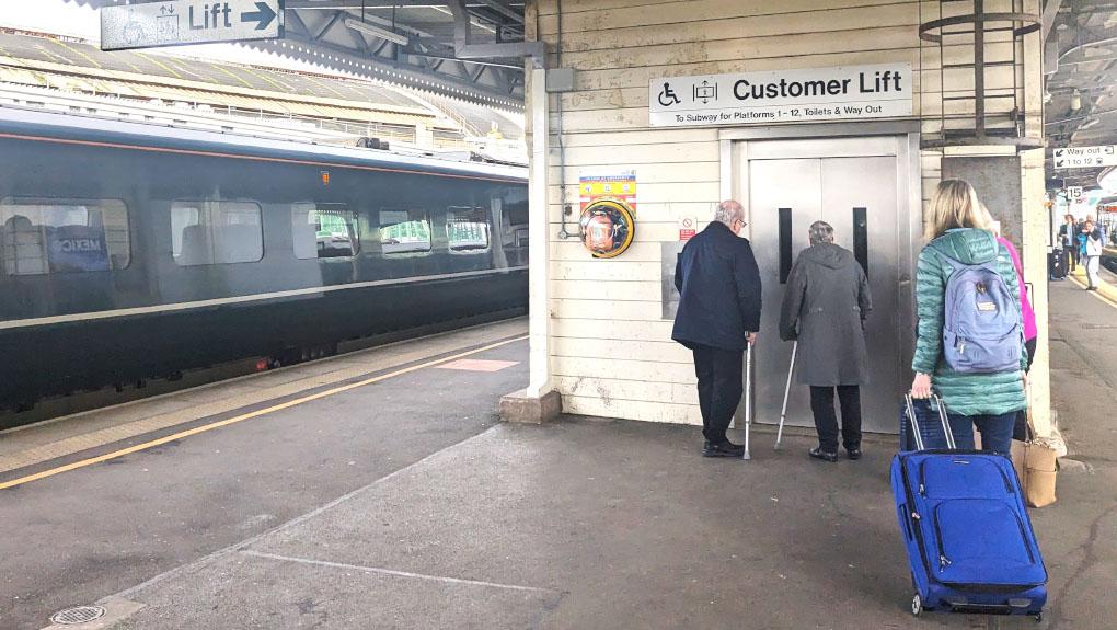 Passengers using a lift at a railway station