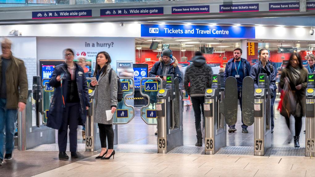 Passengers through ticket gates at Manchester Piccadilly station