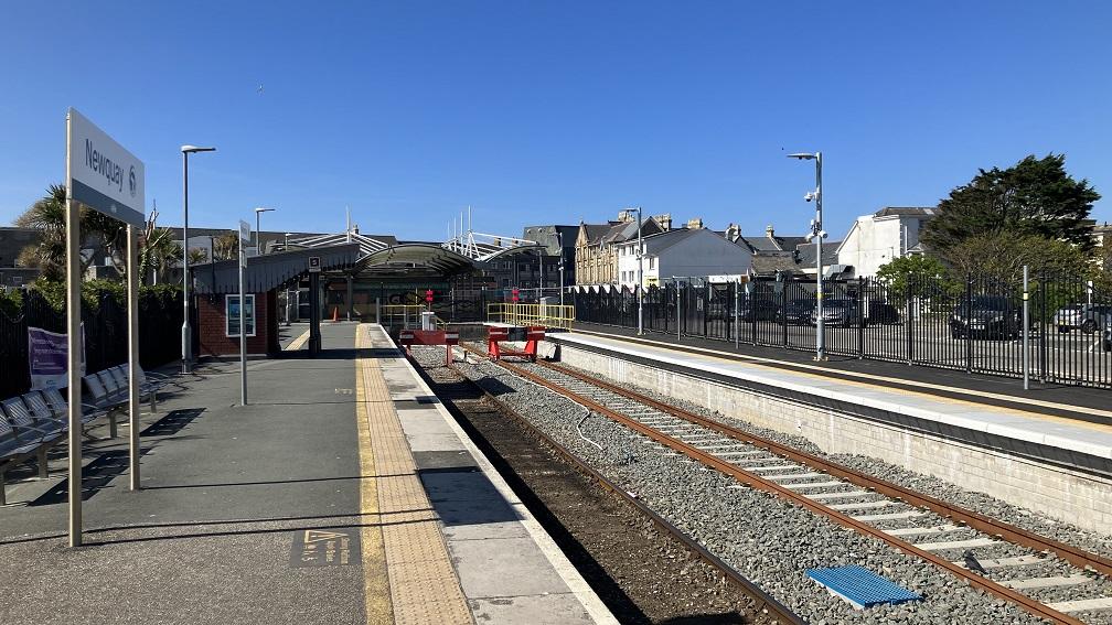 Newquay station, with the station sign on the left and the new platform on the right in the background.