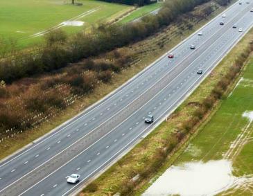 Aerial view of the M11 motorway running through the farmland of Cambridgeshire