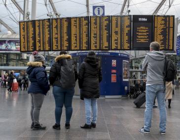 Passengers looking at departure board