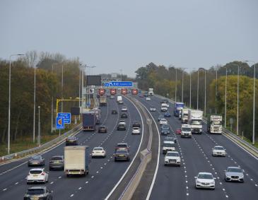 Photo of a motorway, with variable speed signs